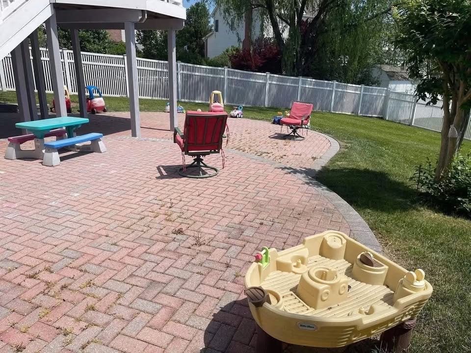 Backyard patio with children's toys furniture and chairs