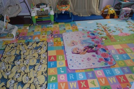 Playroom with colorful alphabet floor mats and blankets