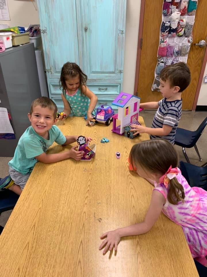 Children playing with toys at a table