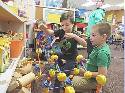 Children playing with building toys in a classroom