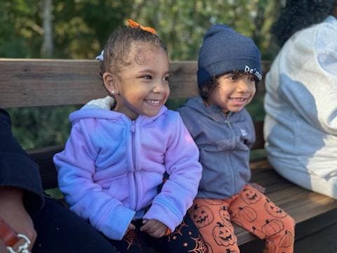 Two children sitting on a bench
