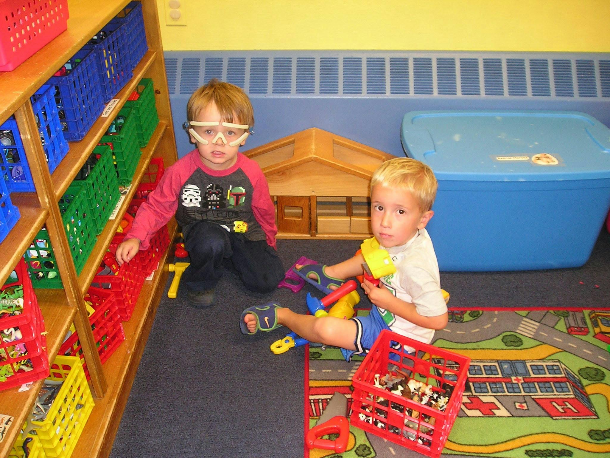Two children playing with toys on the floor