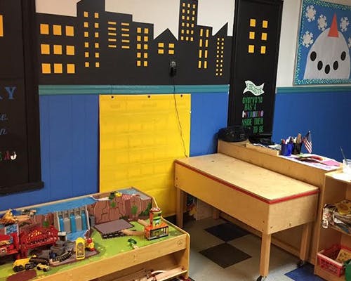 Classroom with a play table and a wooden desk