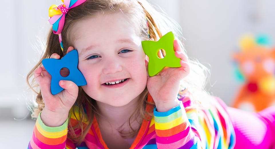 Child holding two star-shaped toys