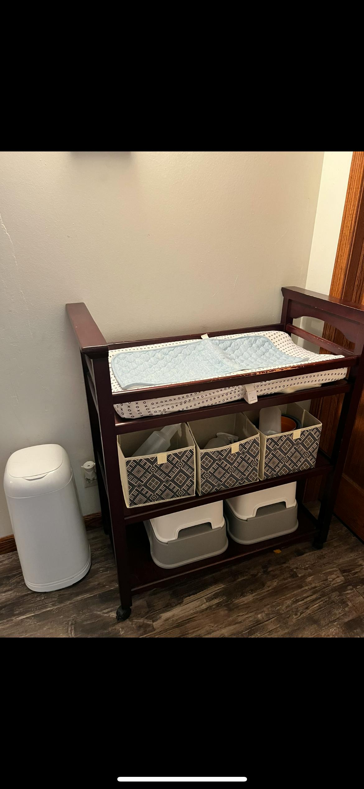 Changing table with storage baskets and a diaper pail