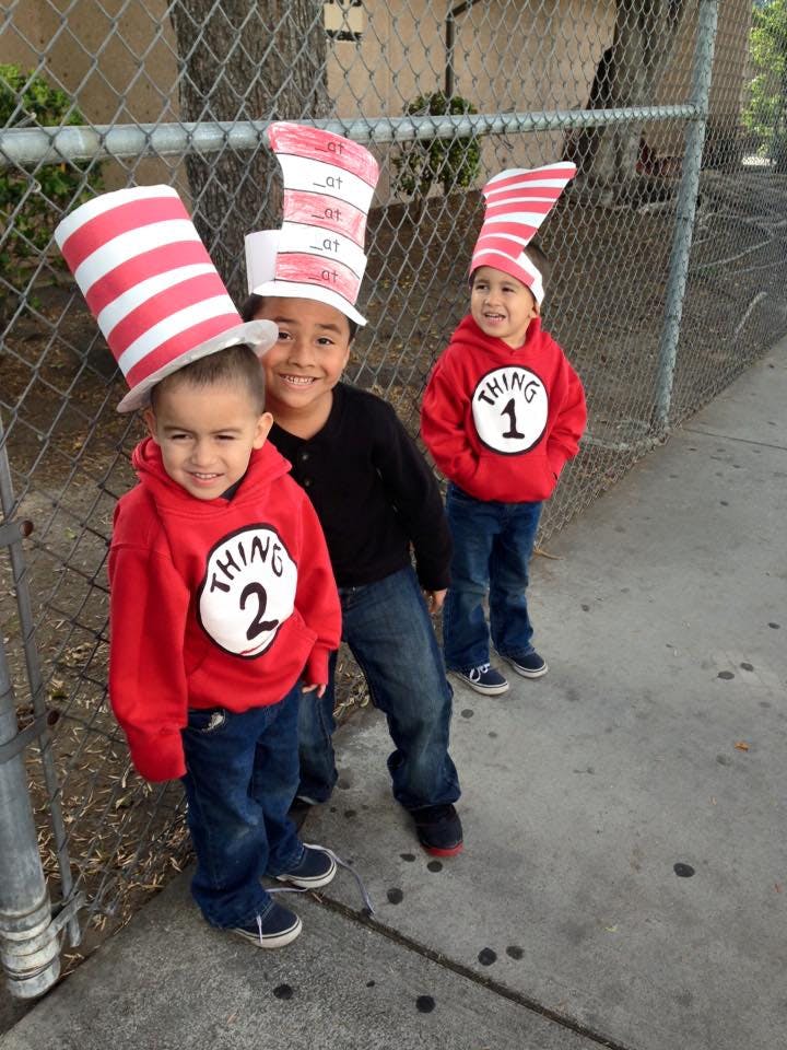Three children wearing Cat in the Hat costumes