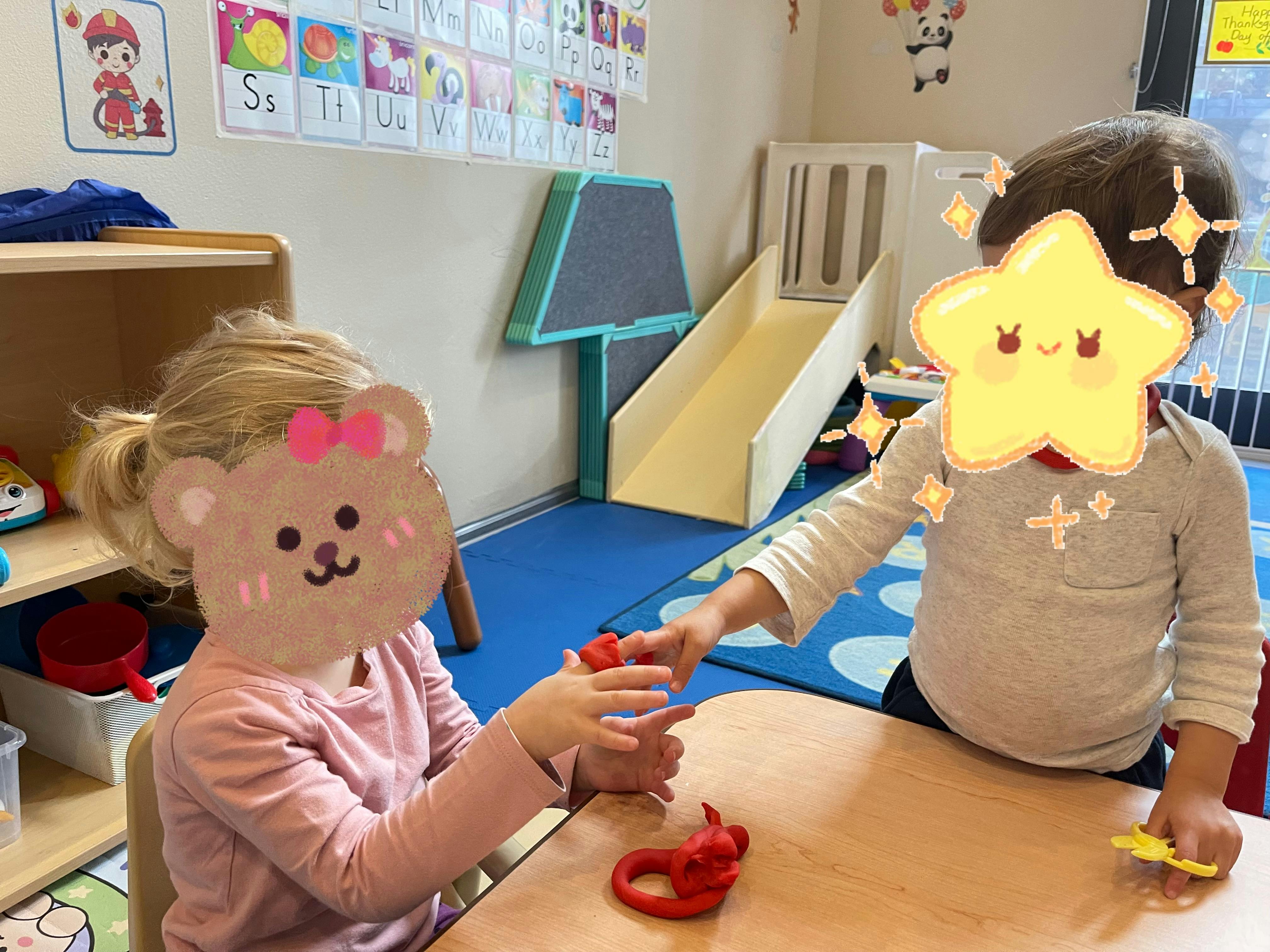 Two children playing with modeling clay at a table