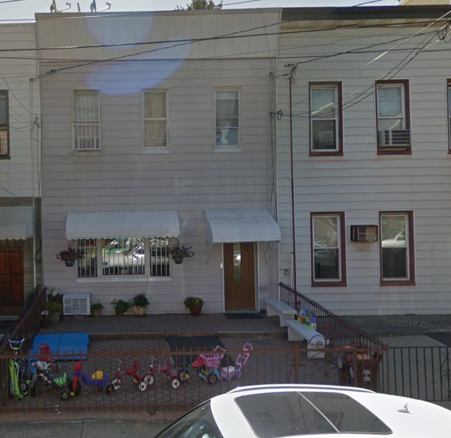 Front of a two-story building with awnings over windows and door