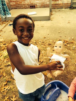 Child holding a doll