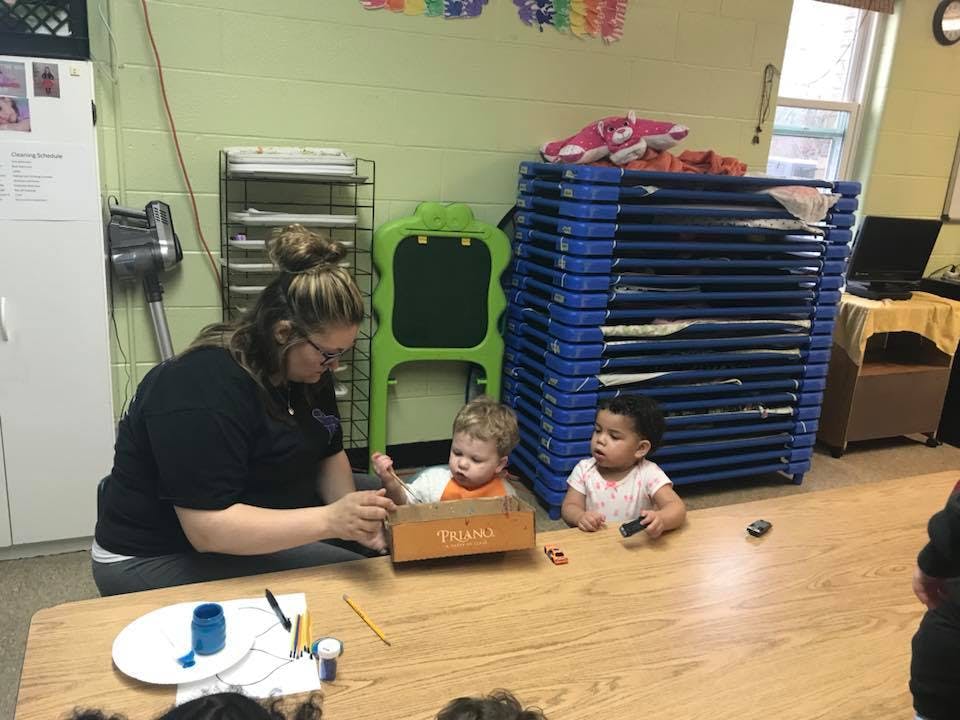 Person and two children at a table