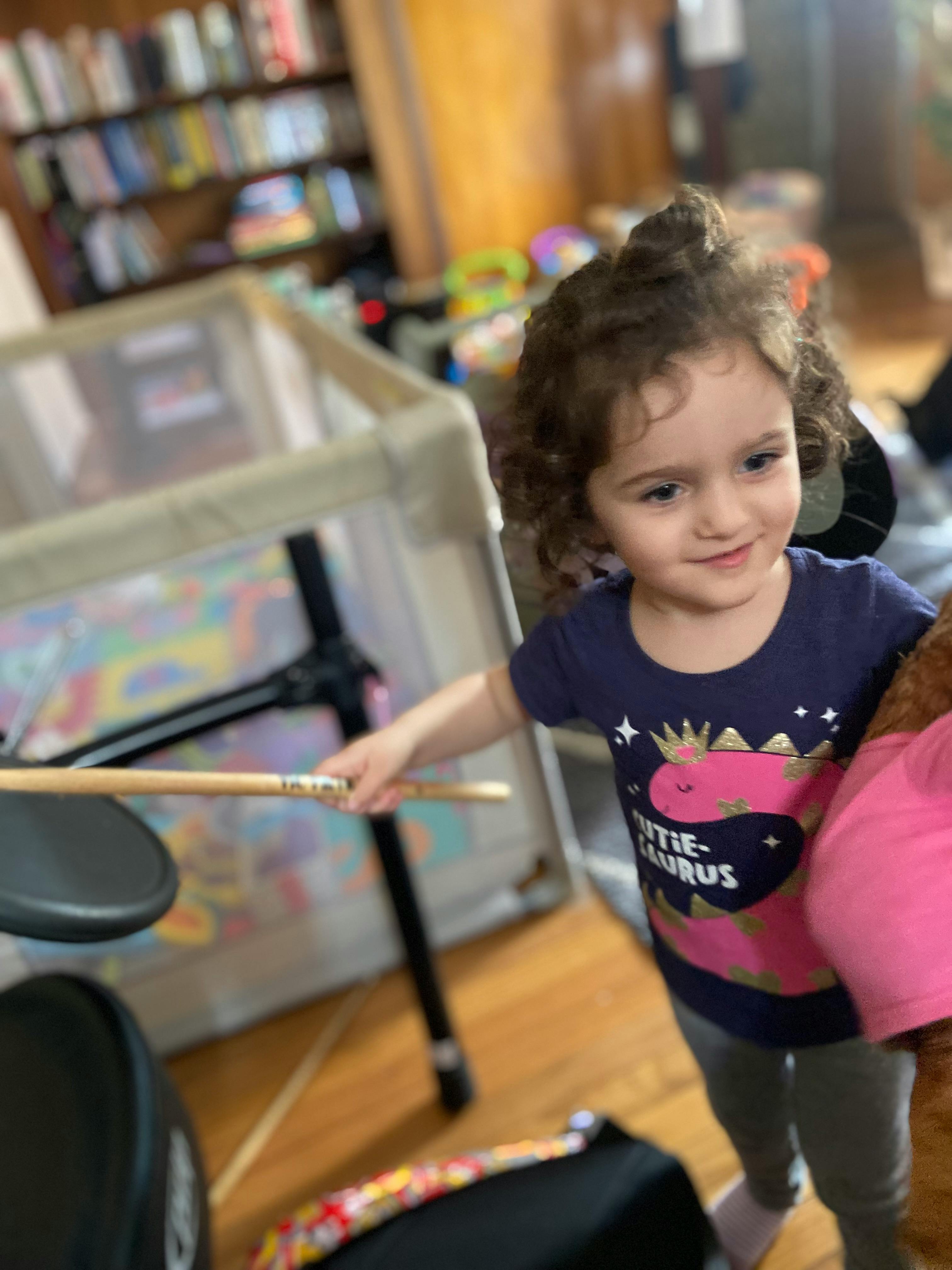 Child holding a drumstick