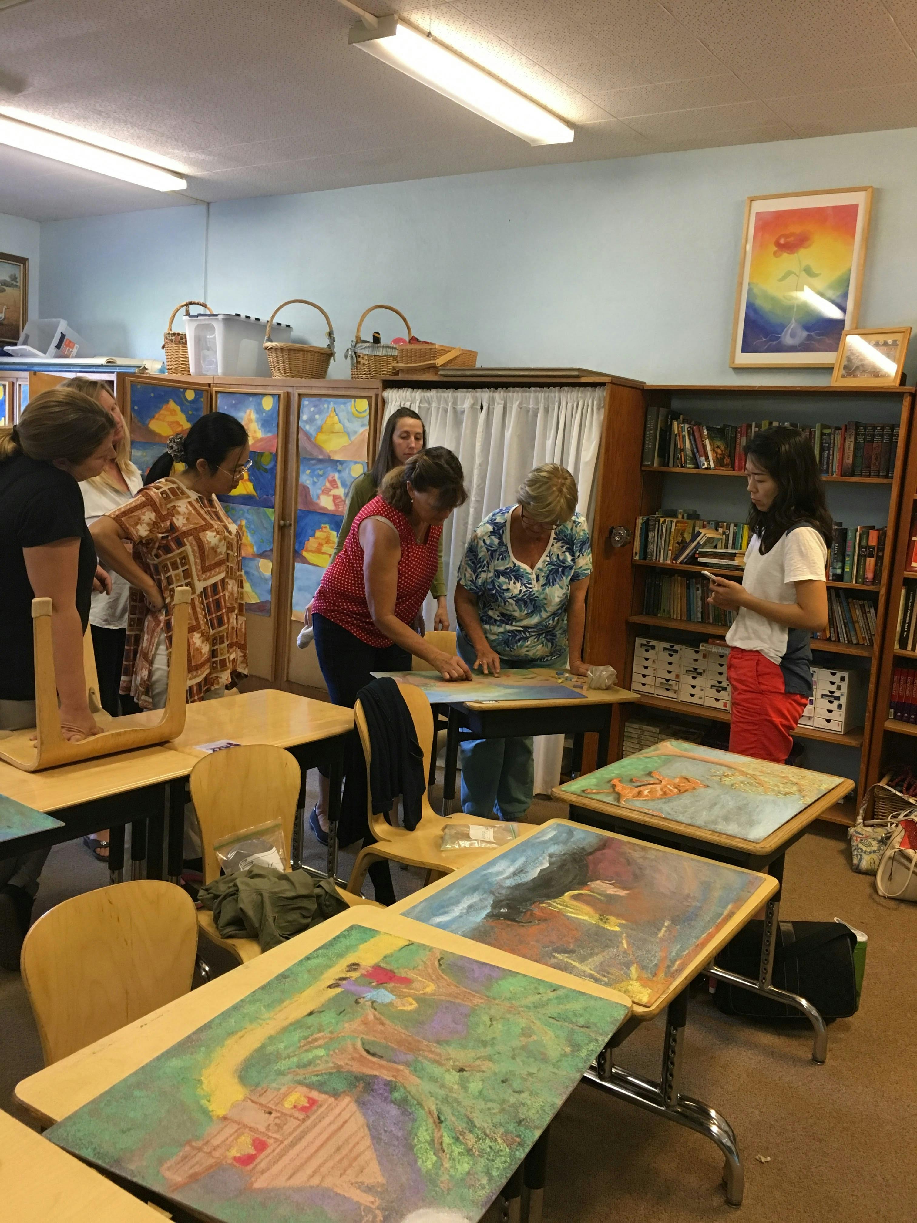 People gathered around tables in a classroom