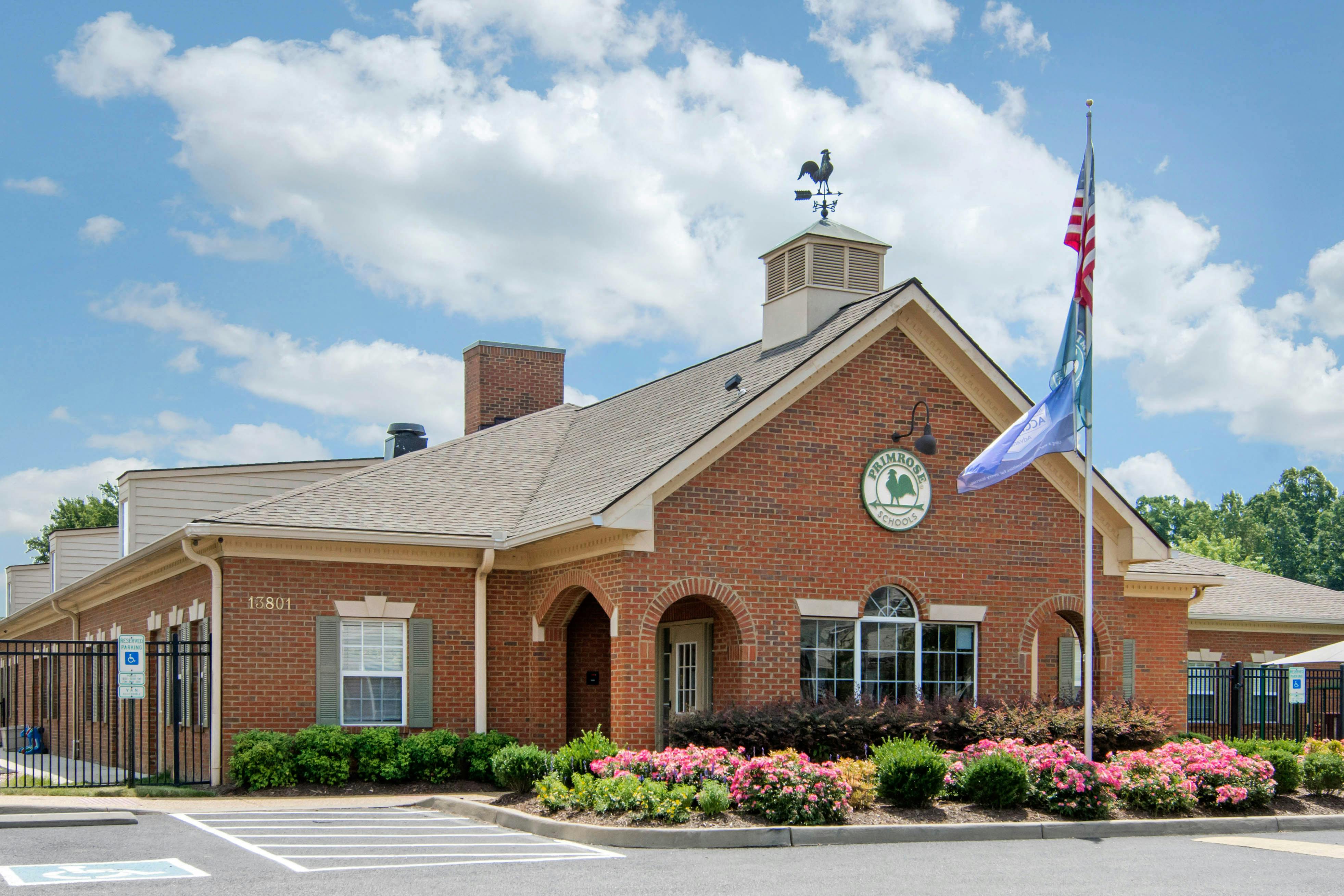 Brick building with a weather vane on the roof and an American flag
