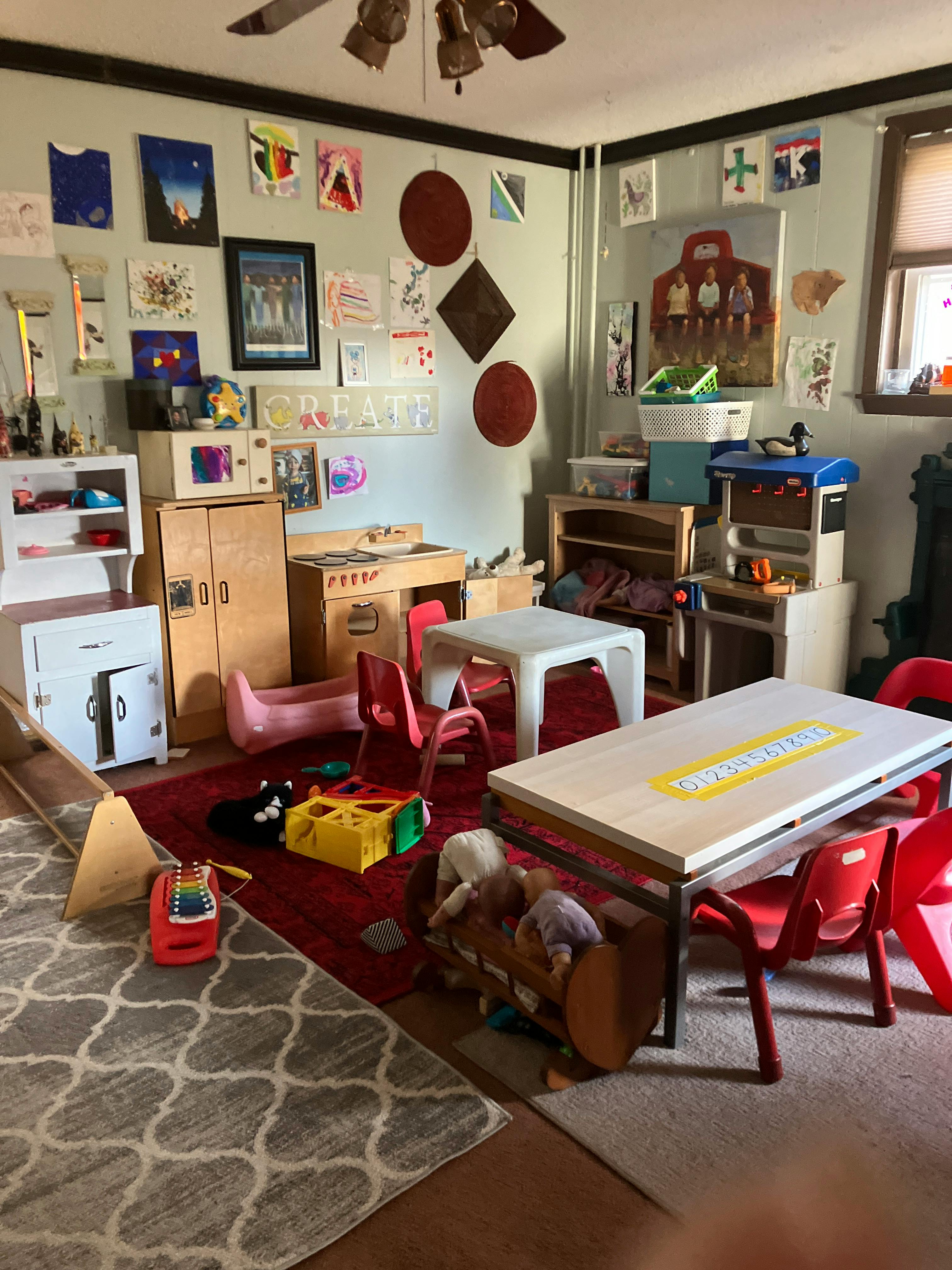 Playroom with small tables, chairs, and toys