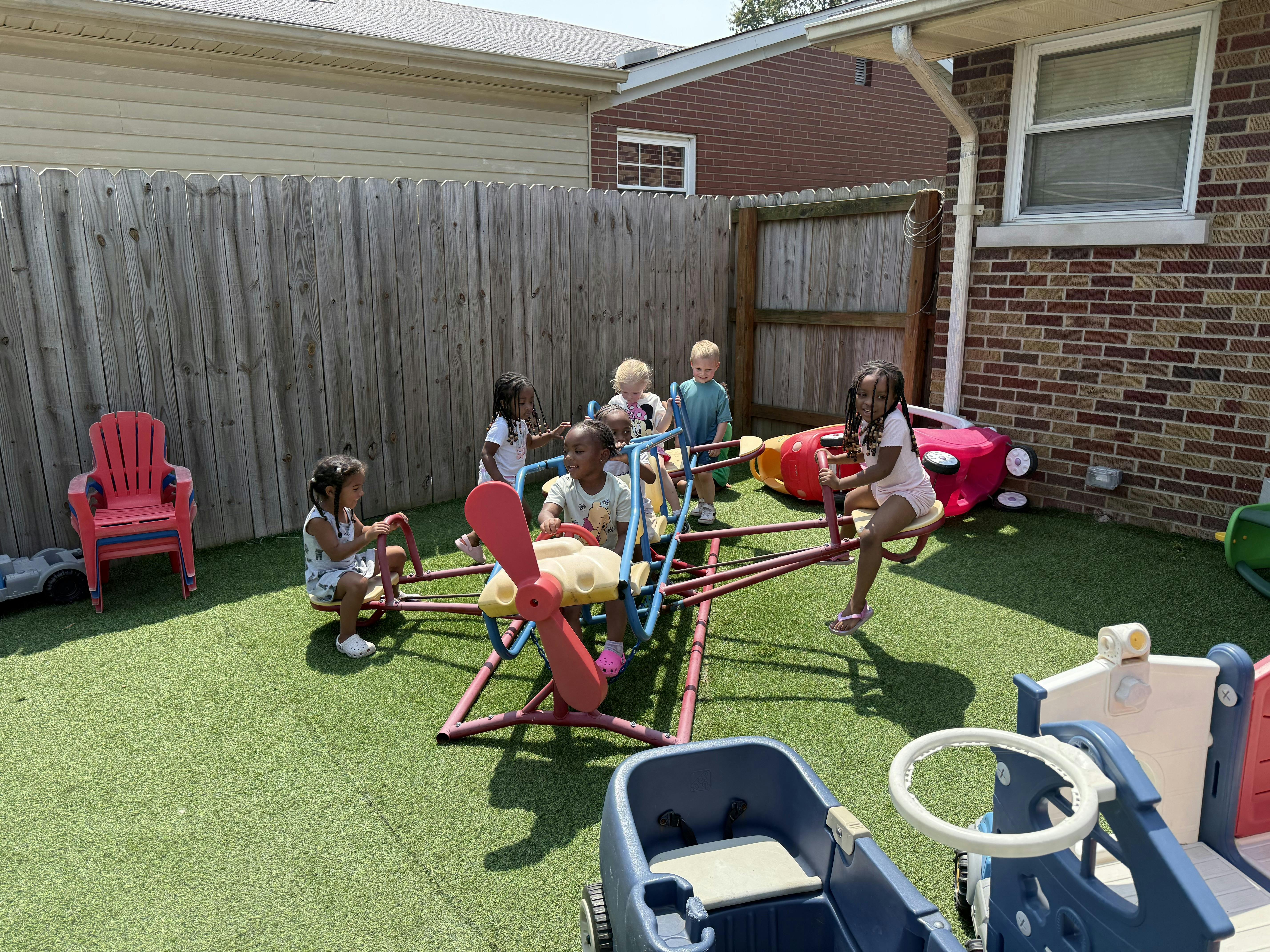 Several children on a playground ride