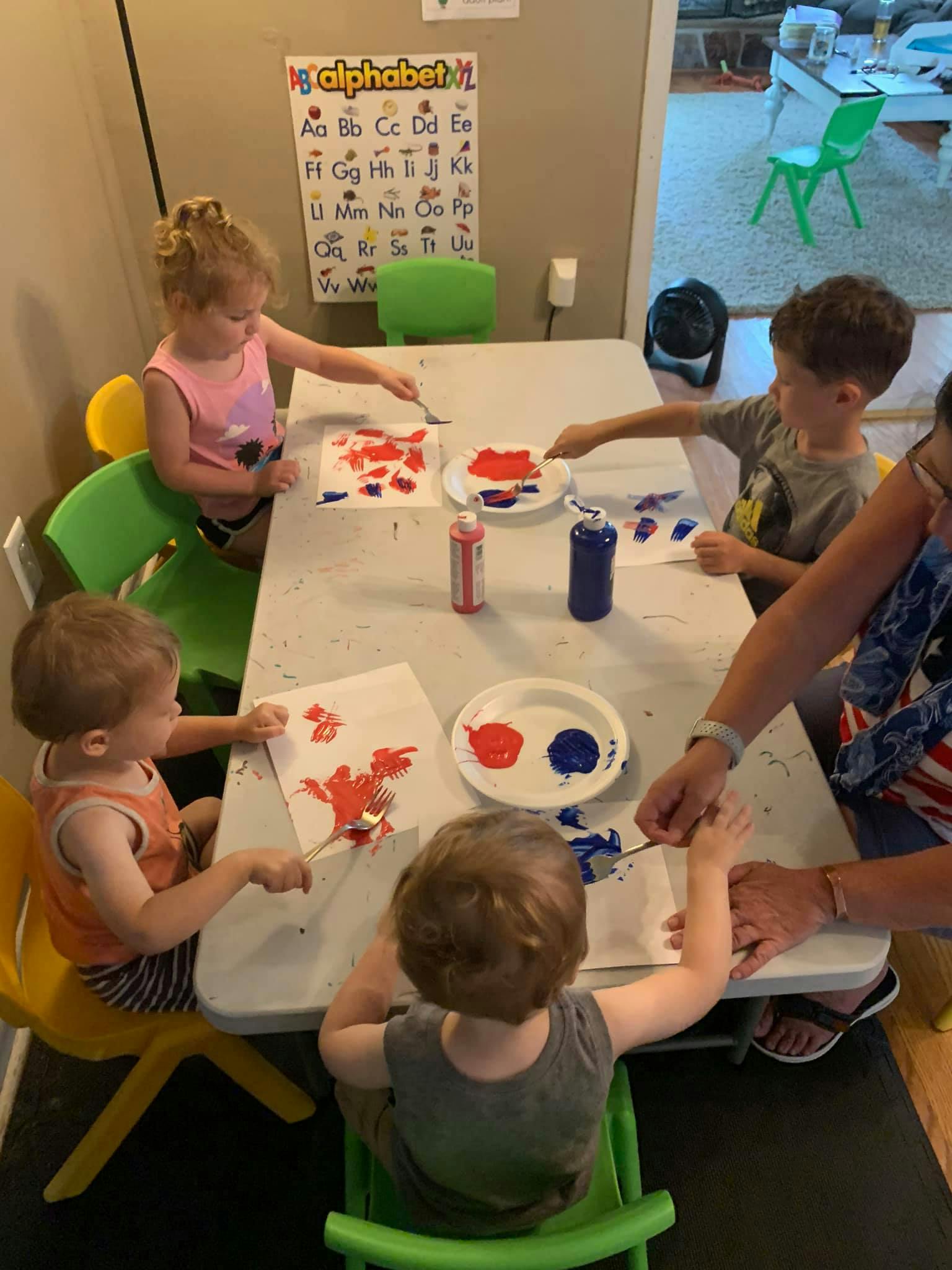 Children painting at a table