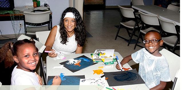 Three people at a table doing crafts