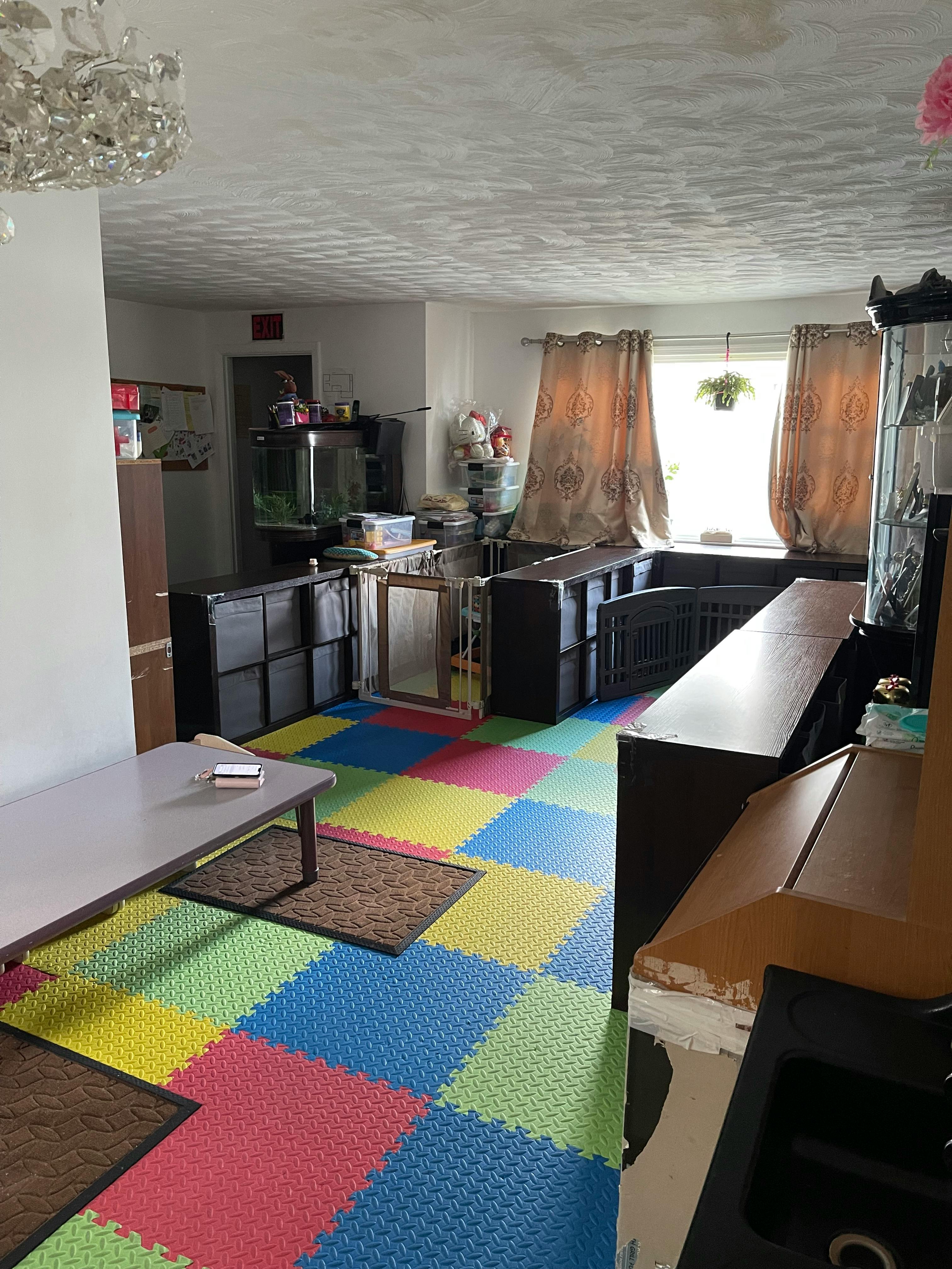 Room with colorful interlocking floor mats and a low table