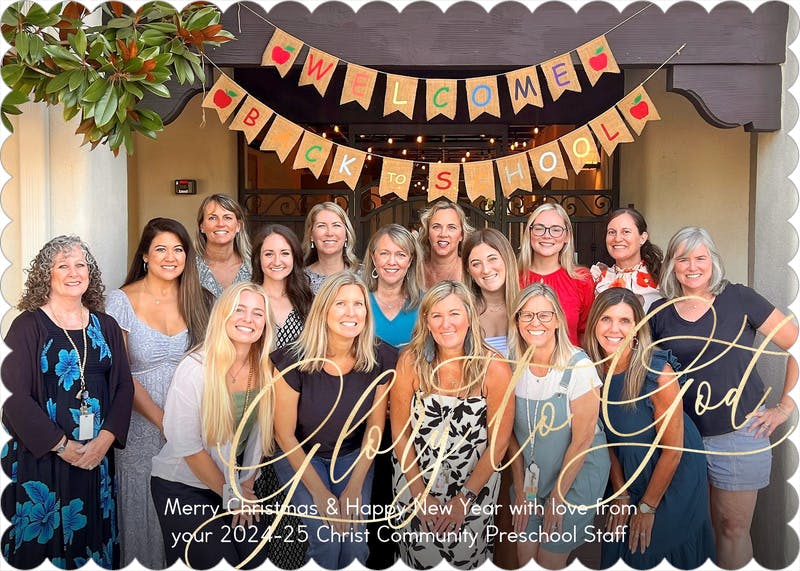 Group of women standing under a banner that says "Welcome Back to School"