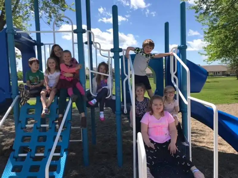 Group of children on a blue and white playground structure