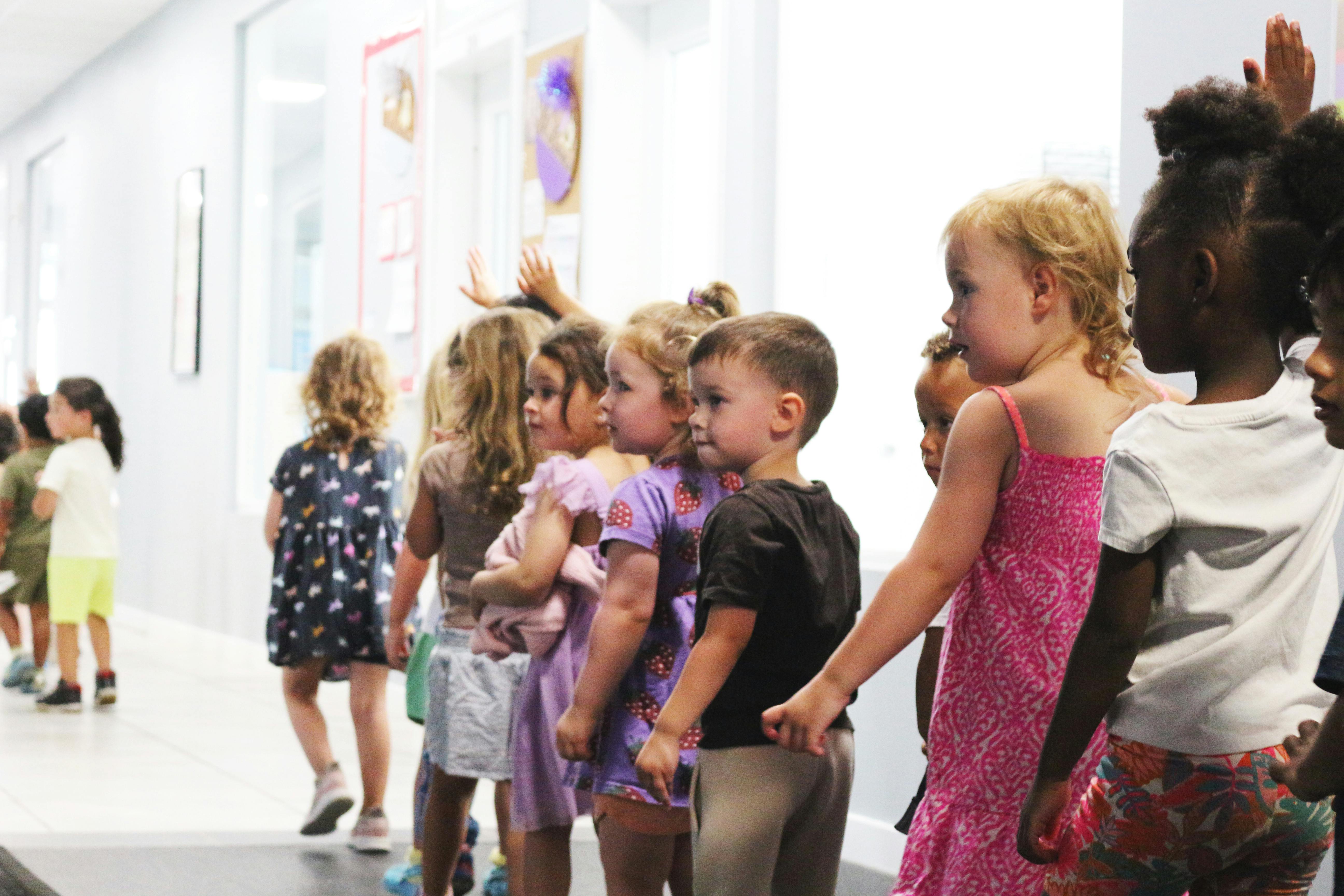 Line of children standing in a hallway