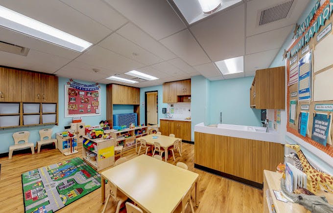 Empty colorful classroom with small tables and chairs