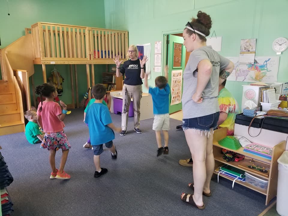 Adults and children in a classroom
