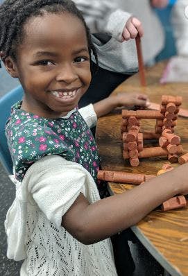 Child playing with wooden building blocks