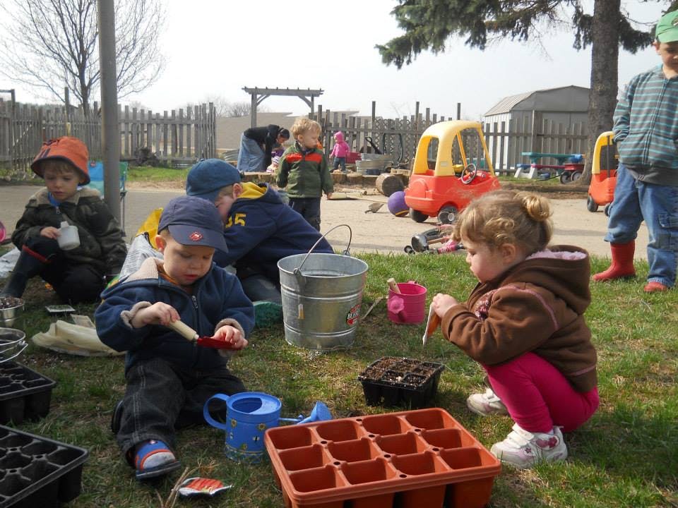 Children planting seeds outdoors