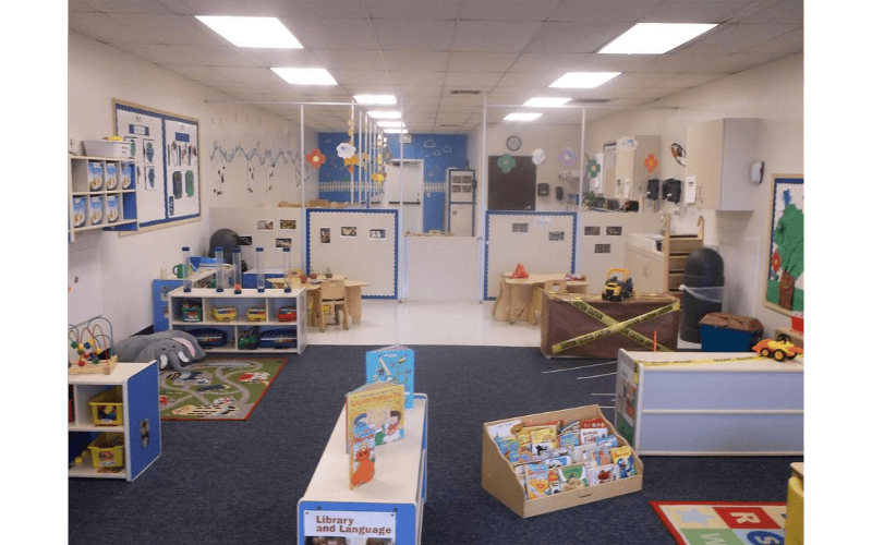 Empty classroom with child-sized furniture and colorful decorations