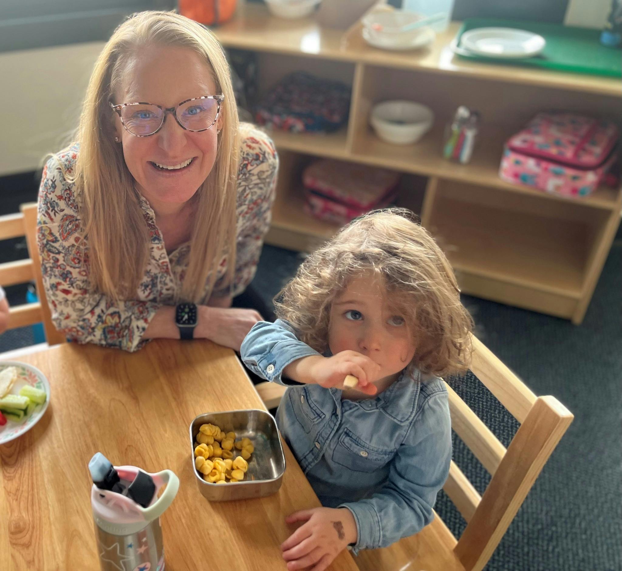 Person and child eating at a table