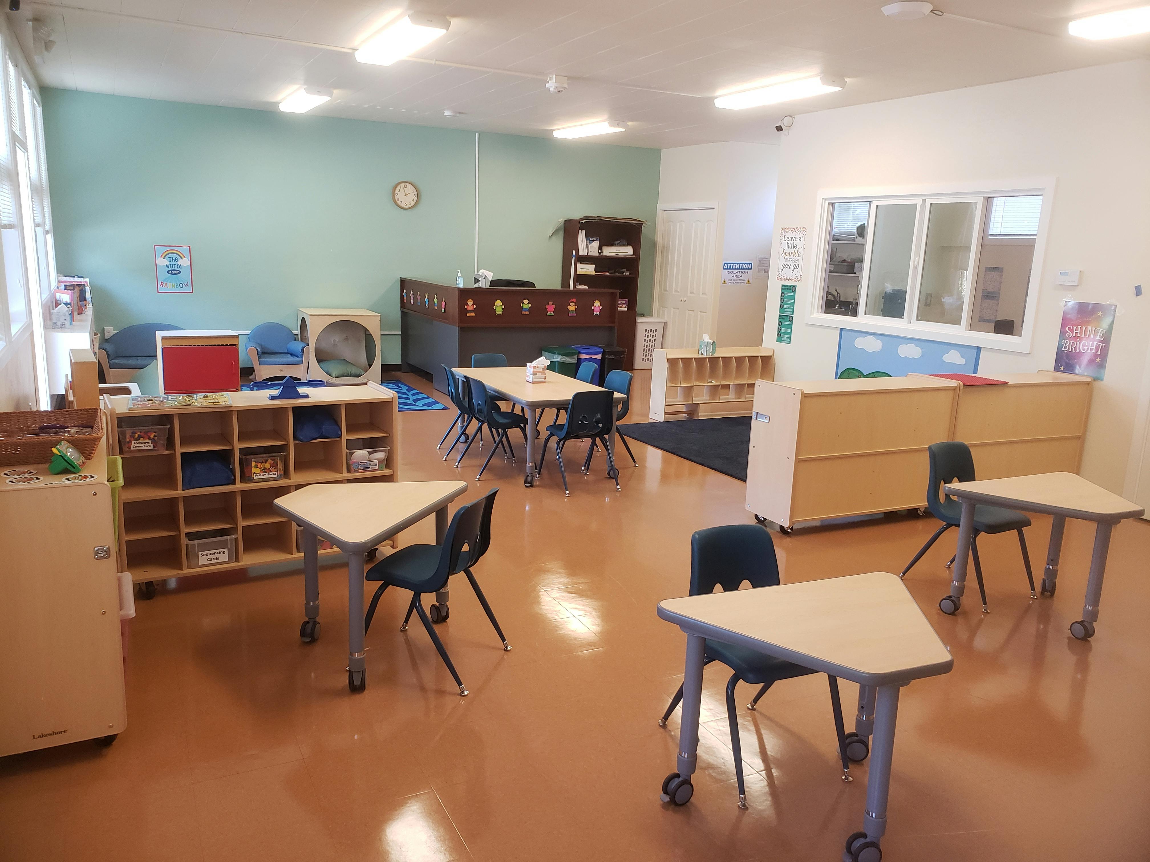 Empty classroom with small tables and chairs
