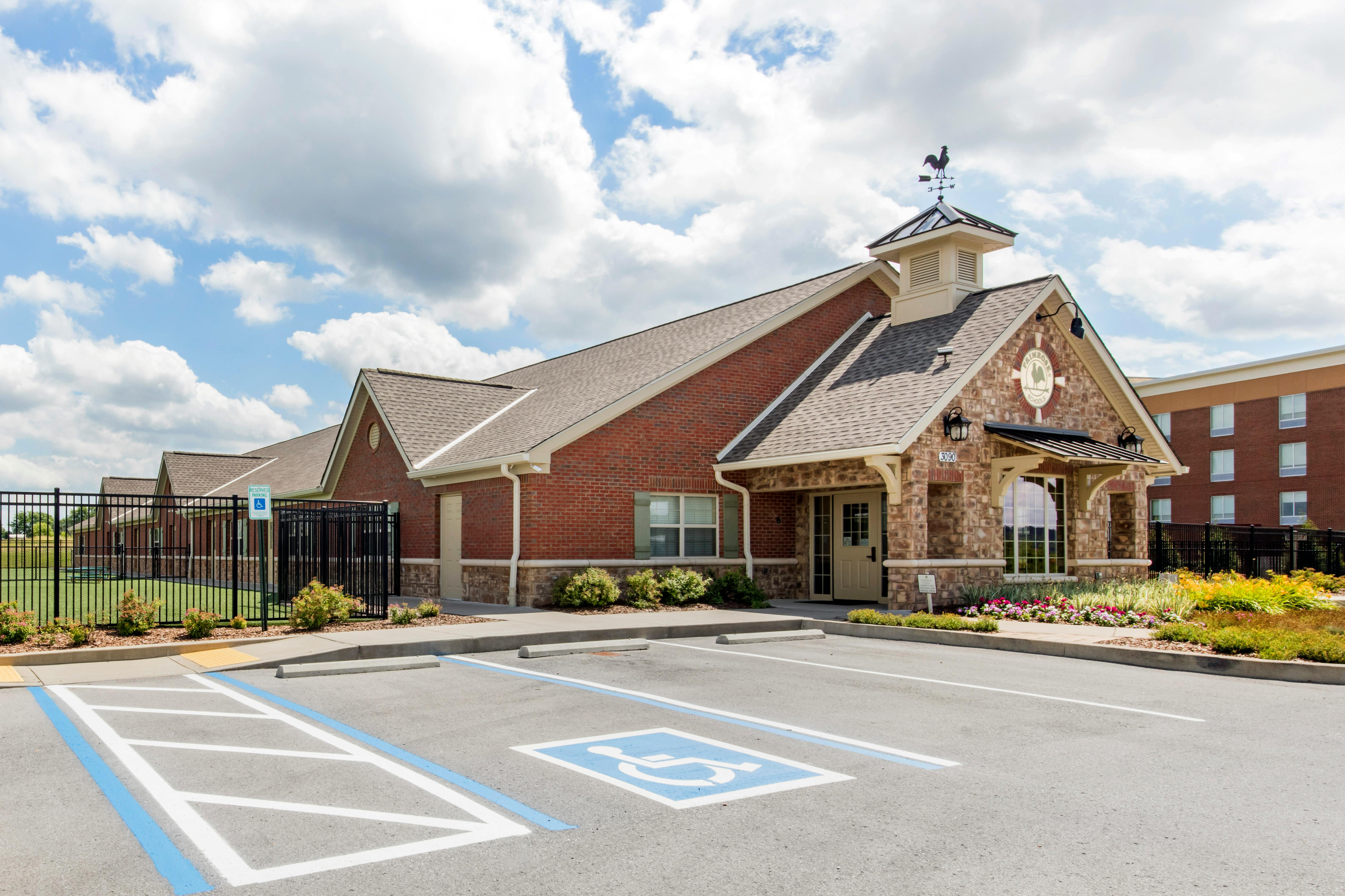 Brick building with a weathervane, parking spaces, and a handicap parking spot