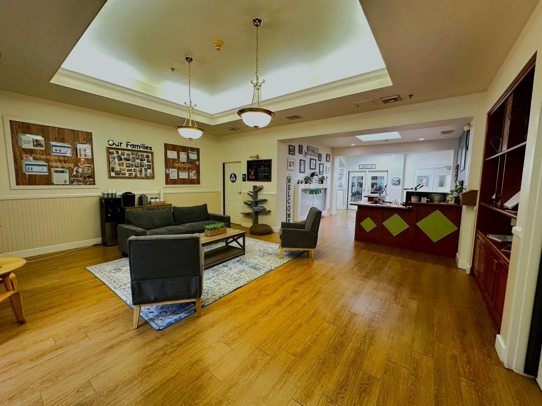 Lobby area with a sofa, chairs, coffee table, and a reception desk