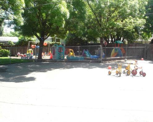 Playground with swings, slides, and tricycles