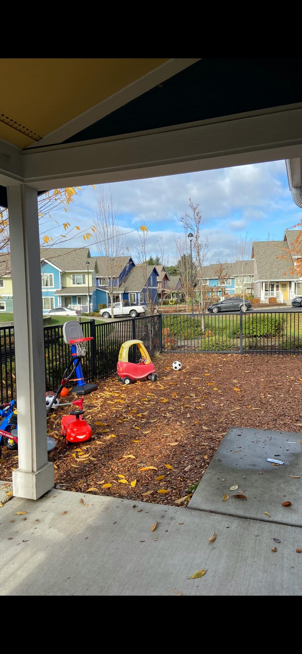 Play area with toy cars, basketball hoop, and soccer ball