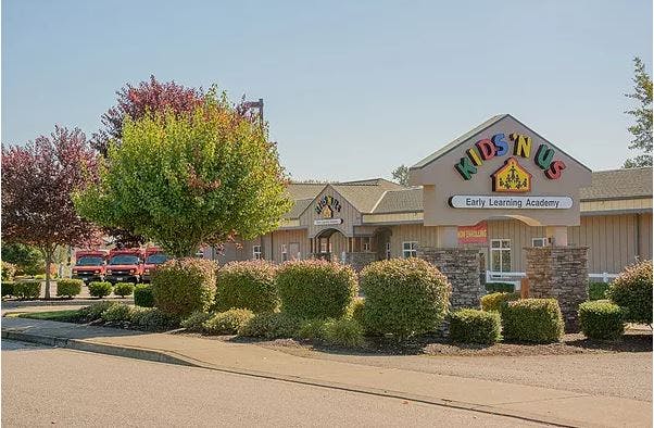Kids 'N Us building exterior with landscaping