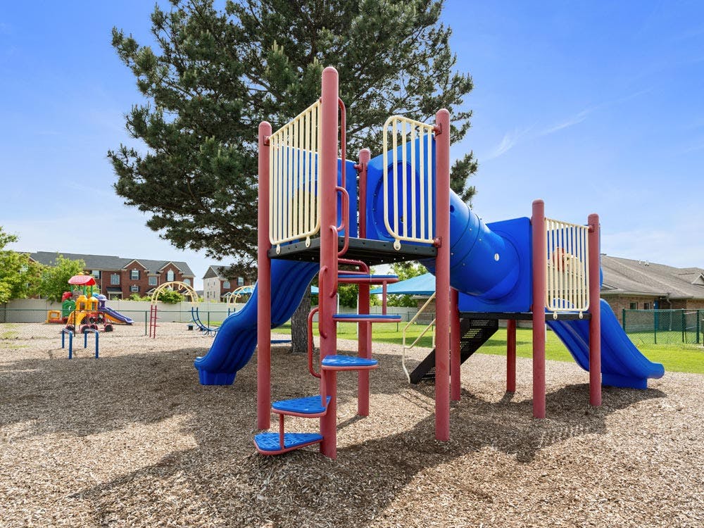 A colorful playground with slides and climbing structures