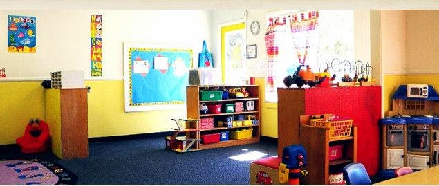 Classroom with toys, shelves, and a bulletin board