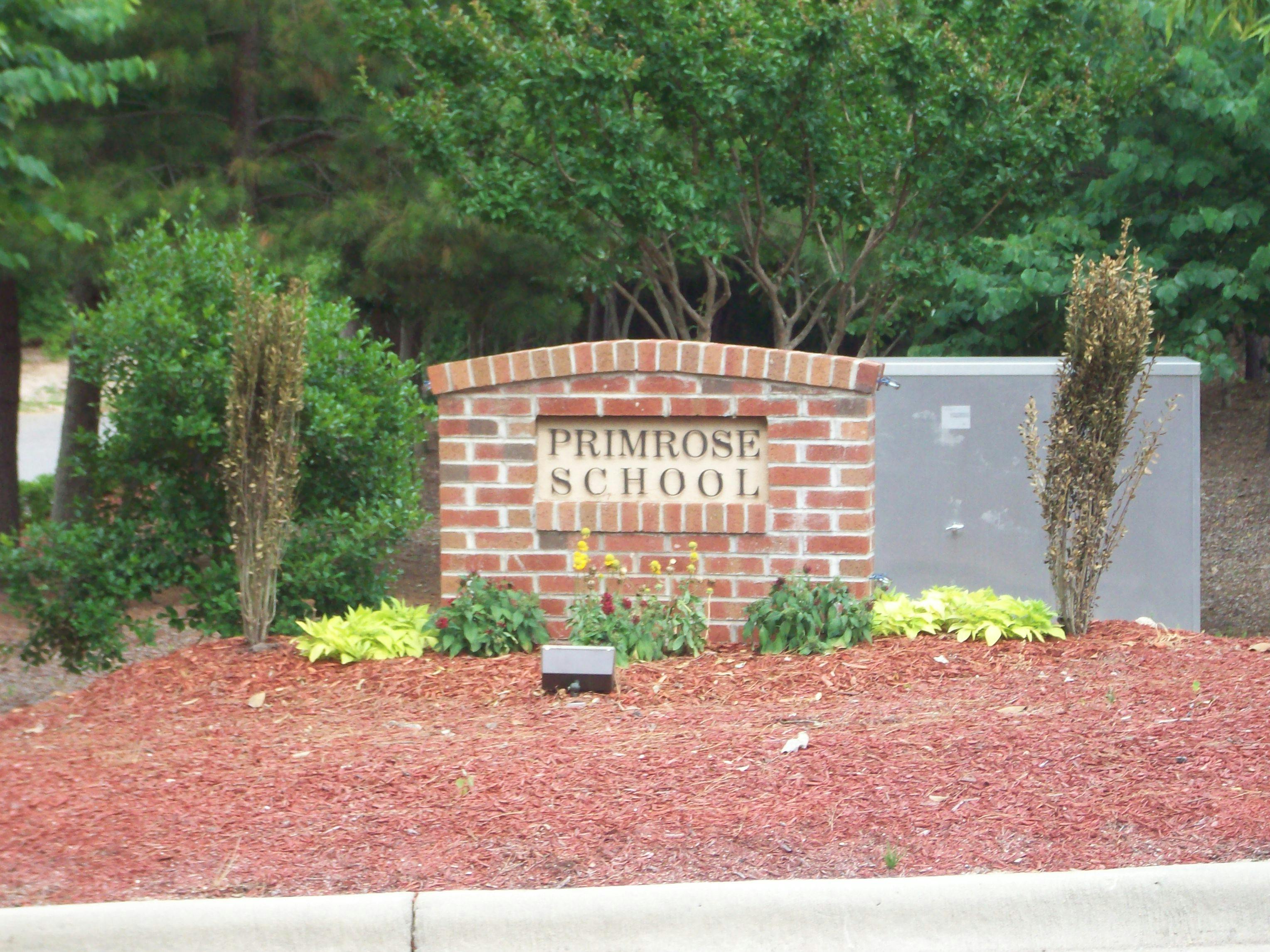 Brick sign for Primrose School with landscaping