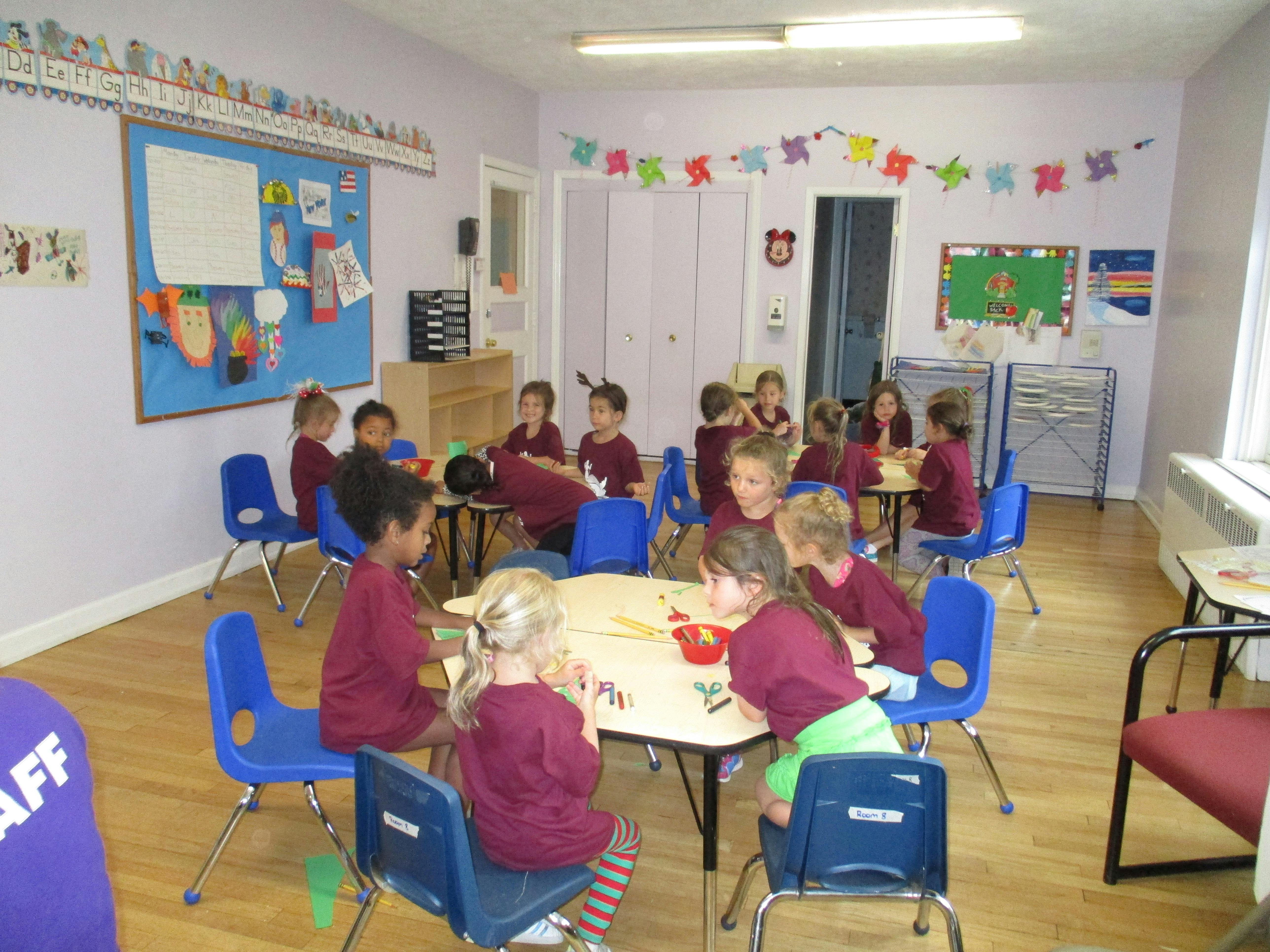 Children sitting at tables in a classroom