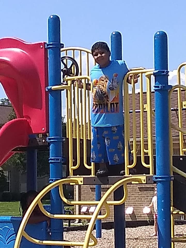 Child standing on a playground structure