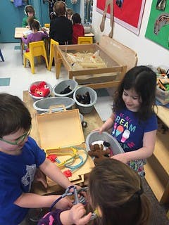 Children playing with toys in a classroom
