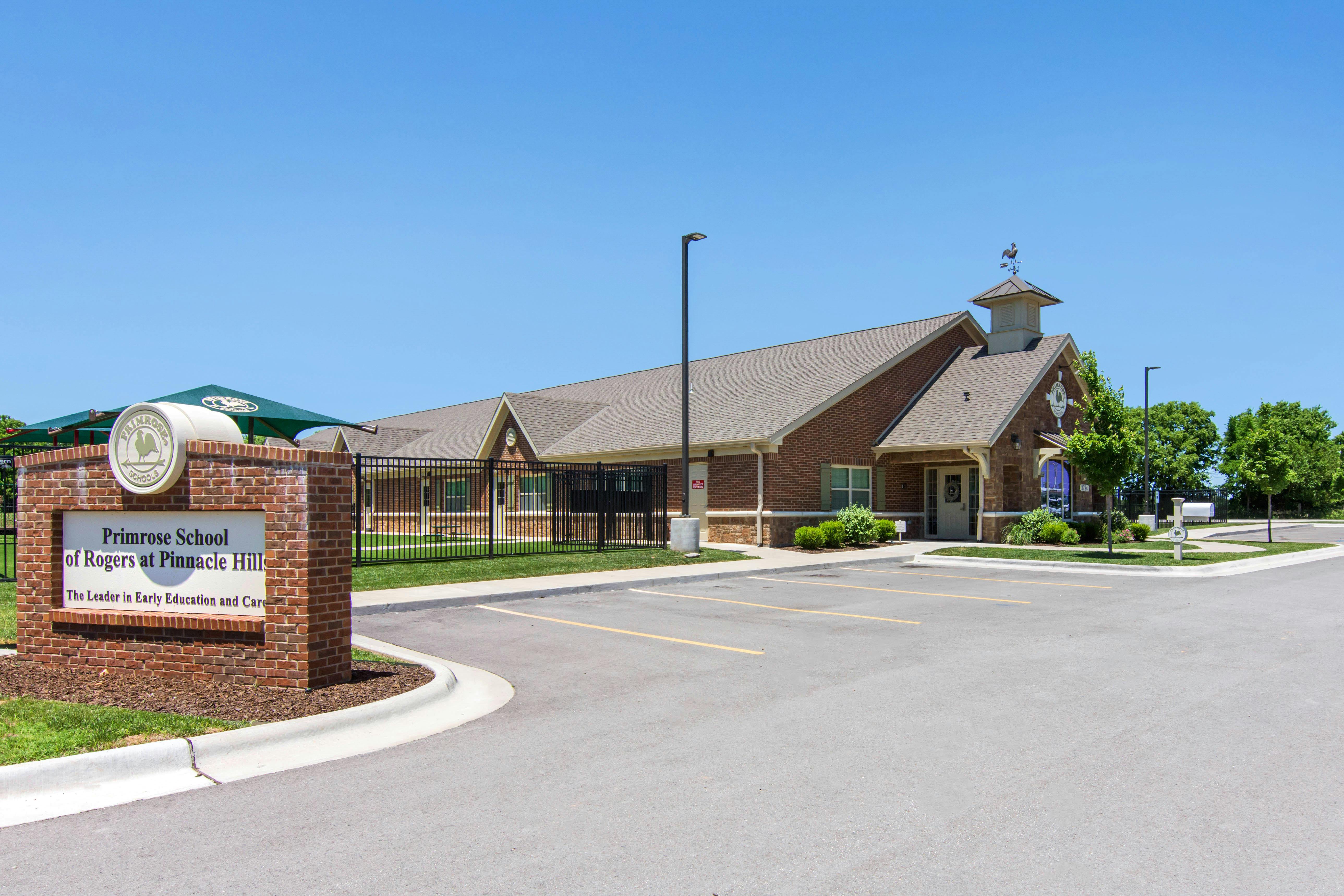 Primrose School of Rogers at Pinnacle Hills building and sign in front of a parking lot