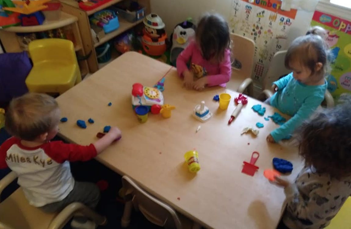 Children playing with modeling clay at a table