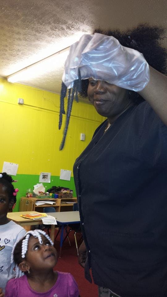 Person holding a plastic bag over their head, child looking up