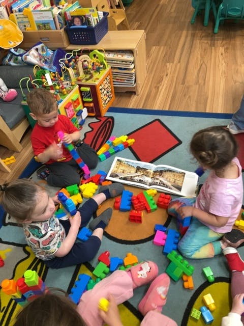Children playing with building blocks in a classroom