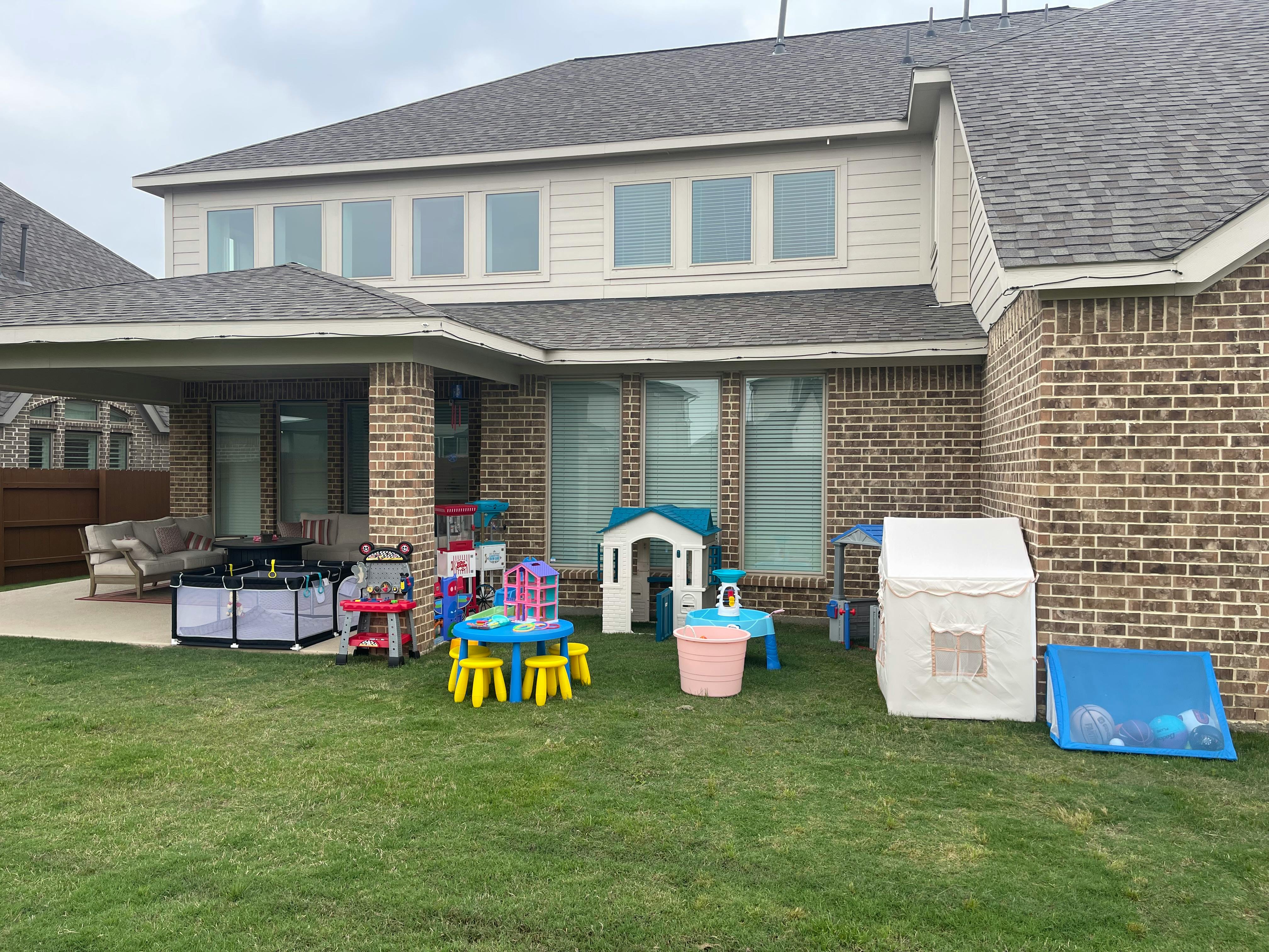 Backyard with children's play equipment on grass
