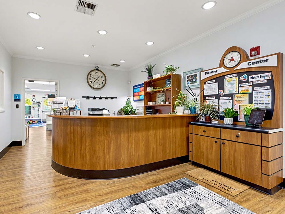 Reception area with a wooden counter and a bulletin board