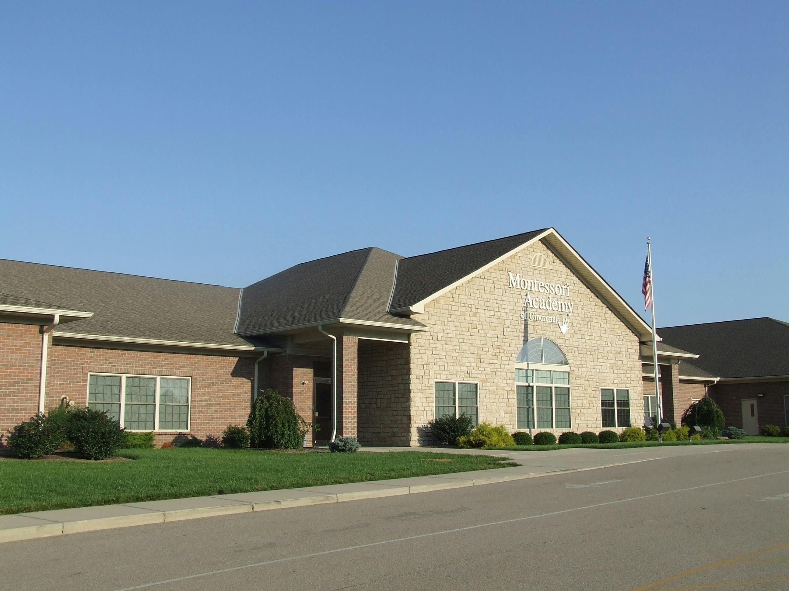 Brick building with a gabled roof and a flagpole